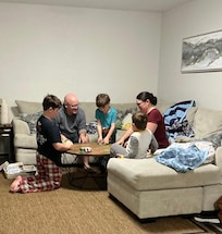 My family playing one of the many board/card games supplied with the house.