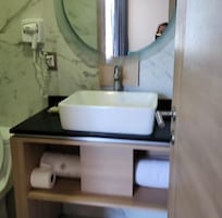 Mirrors with lights, outlets on the side, towels, liquid and bar soap, and extra toilet paper...