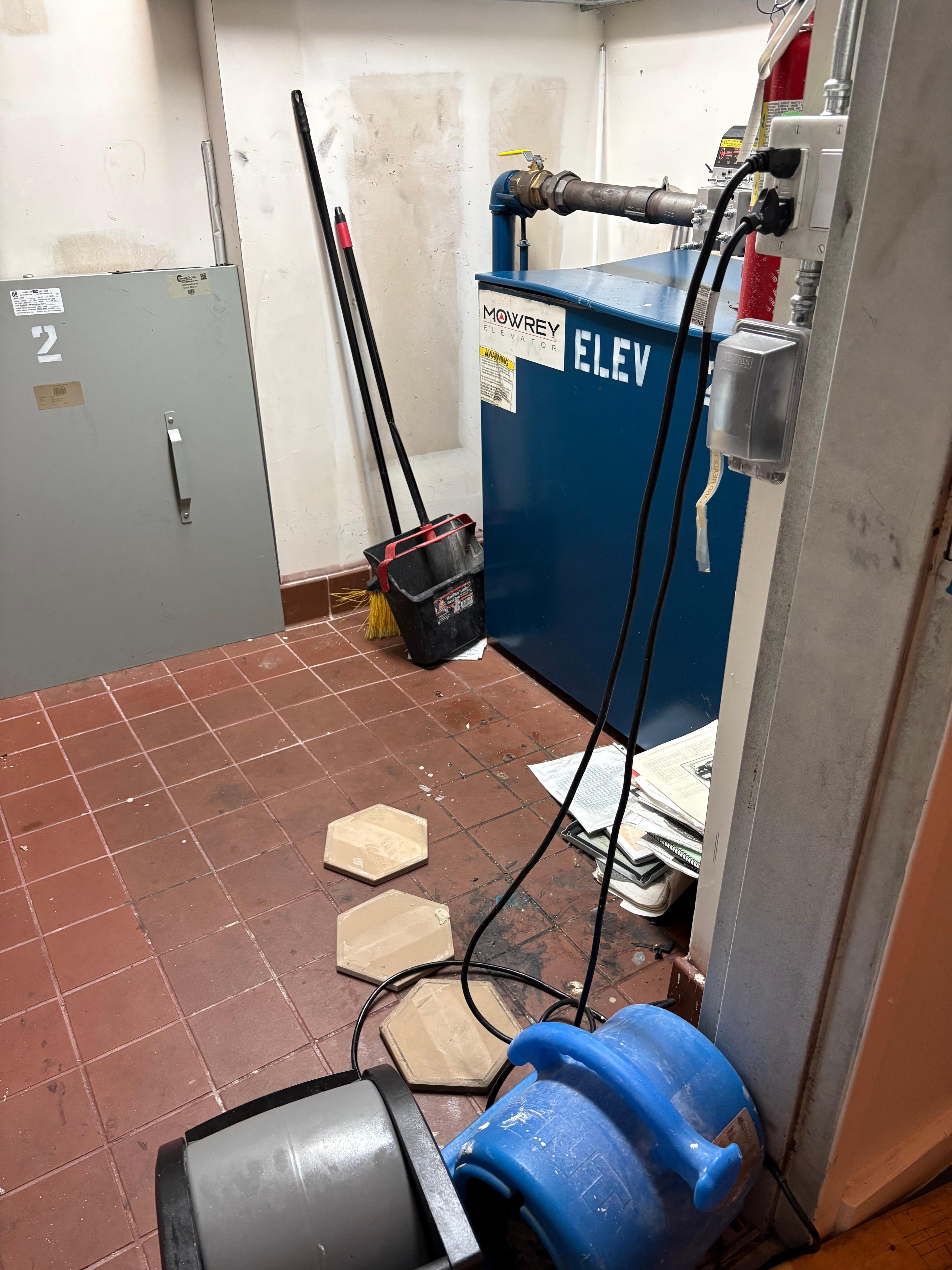 Elevator room over heating, smelling like a belts going out. Asked if there were stairs. Told they were for emergencies only. 