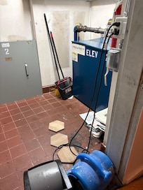 Elevator room over heating, smelling like a belts going out. Asked if there were stairs. Told they were for emergencies only.