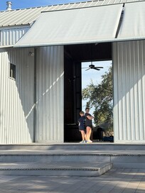 Barn doors open and back porch like a stage.