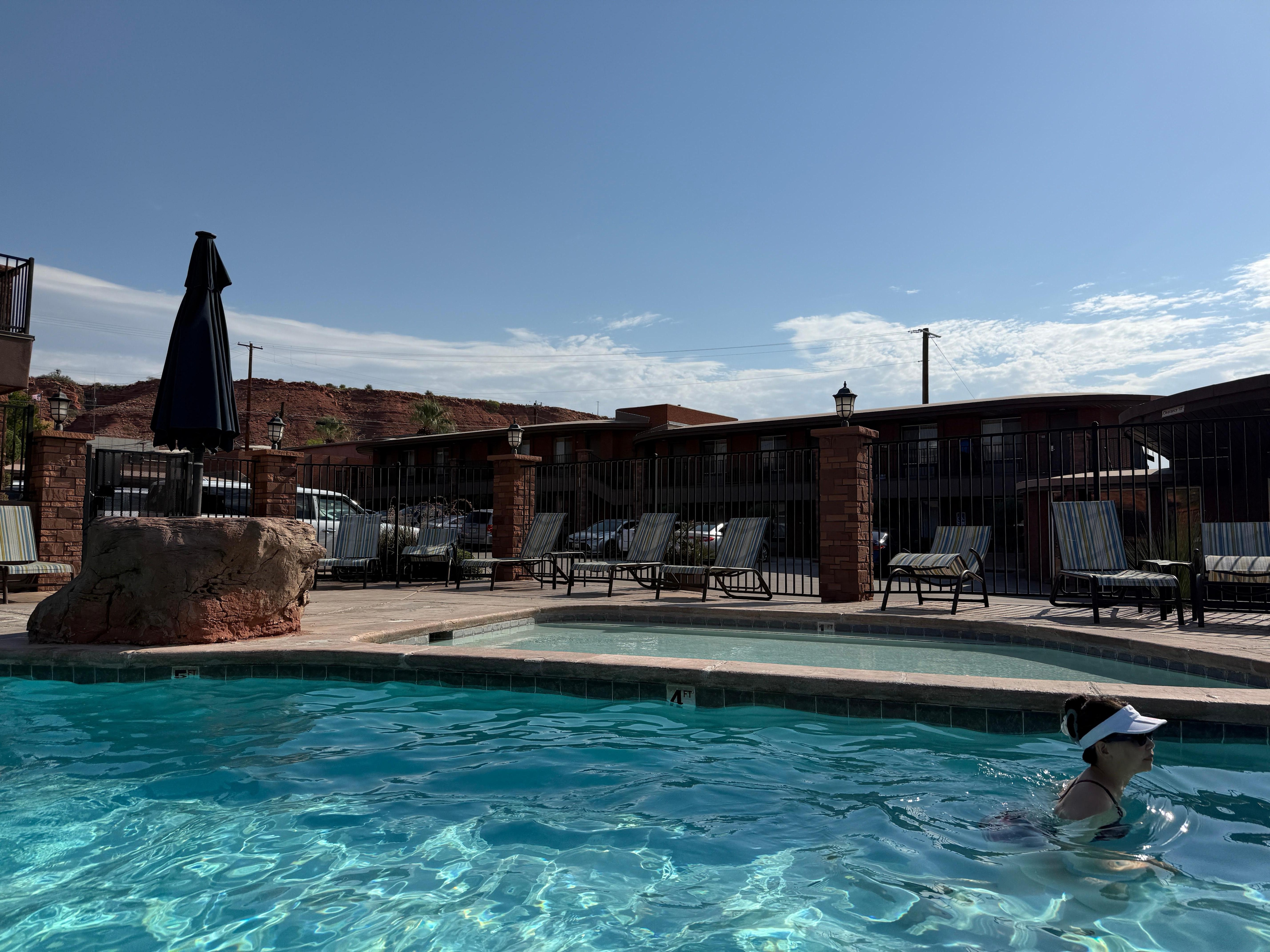 Pool area. Cute waterfall and hot tub area