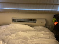 Bed shoved against the AC/heater still no room to move. Window with broken latch.