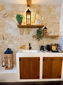 Kitchenette with coffee maker, kettle, sink and fridge