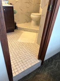 Multi level flooring in bathroom and pocket door that doesn’t secure.