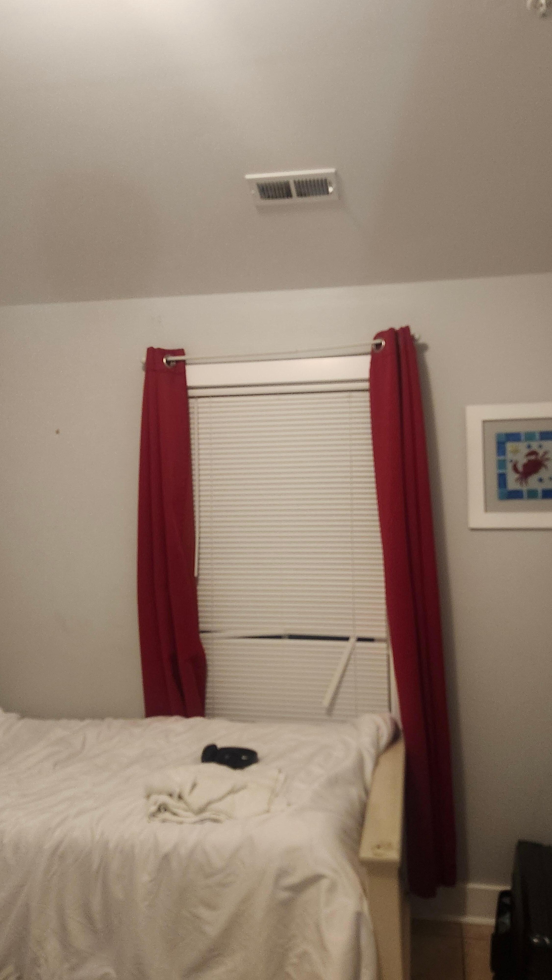 Broken shades throughout the house with used bed sheets and unmade bed.