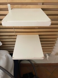 Bedside tables worn and unstable.