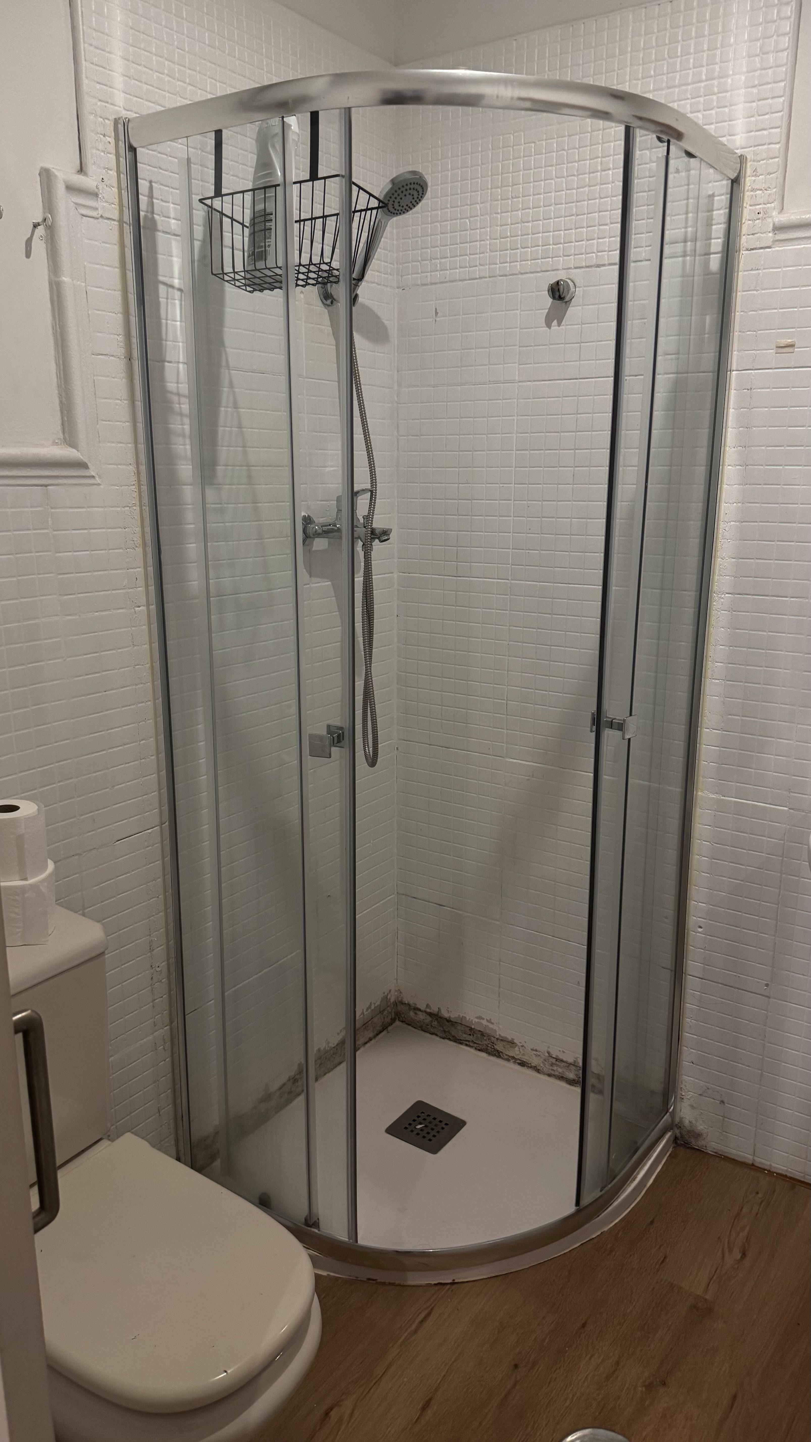 Tiny shower cabin with mold