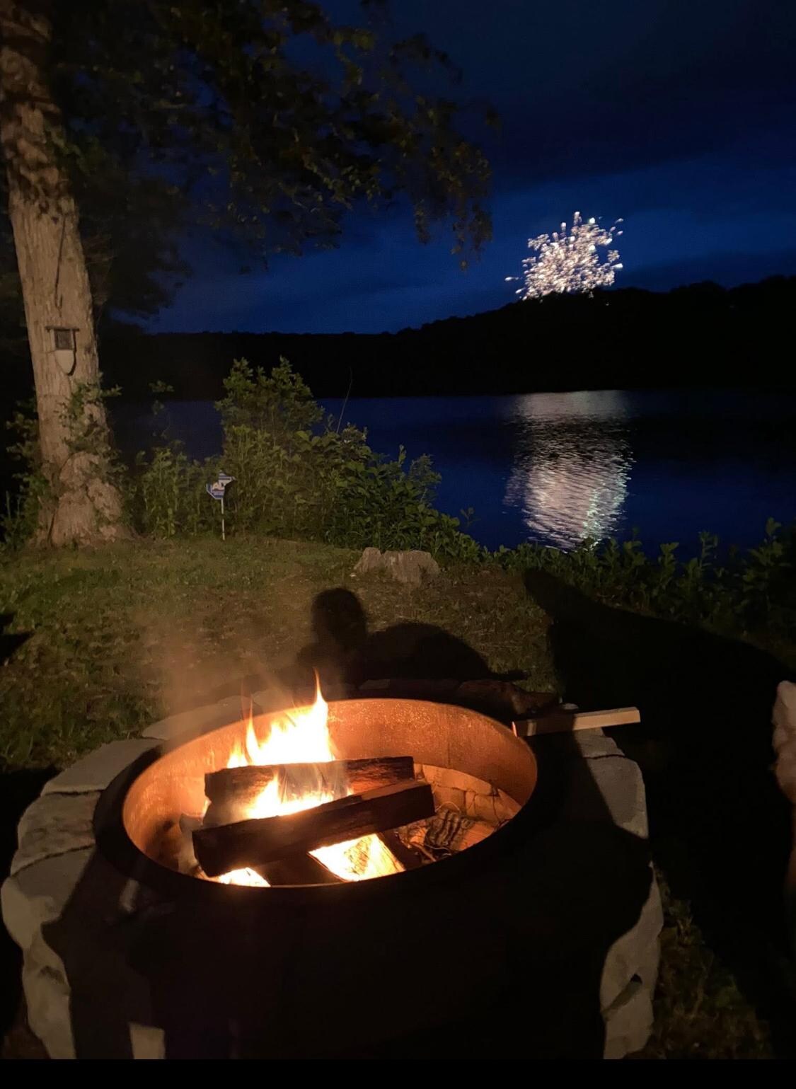 Lakefront fire pit.  Pre-Independence Day fireworks in distance!