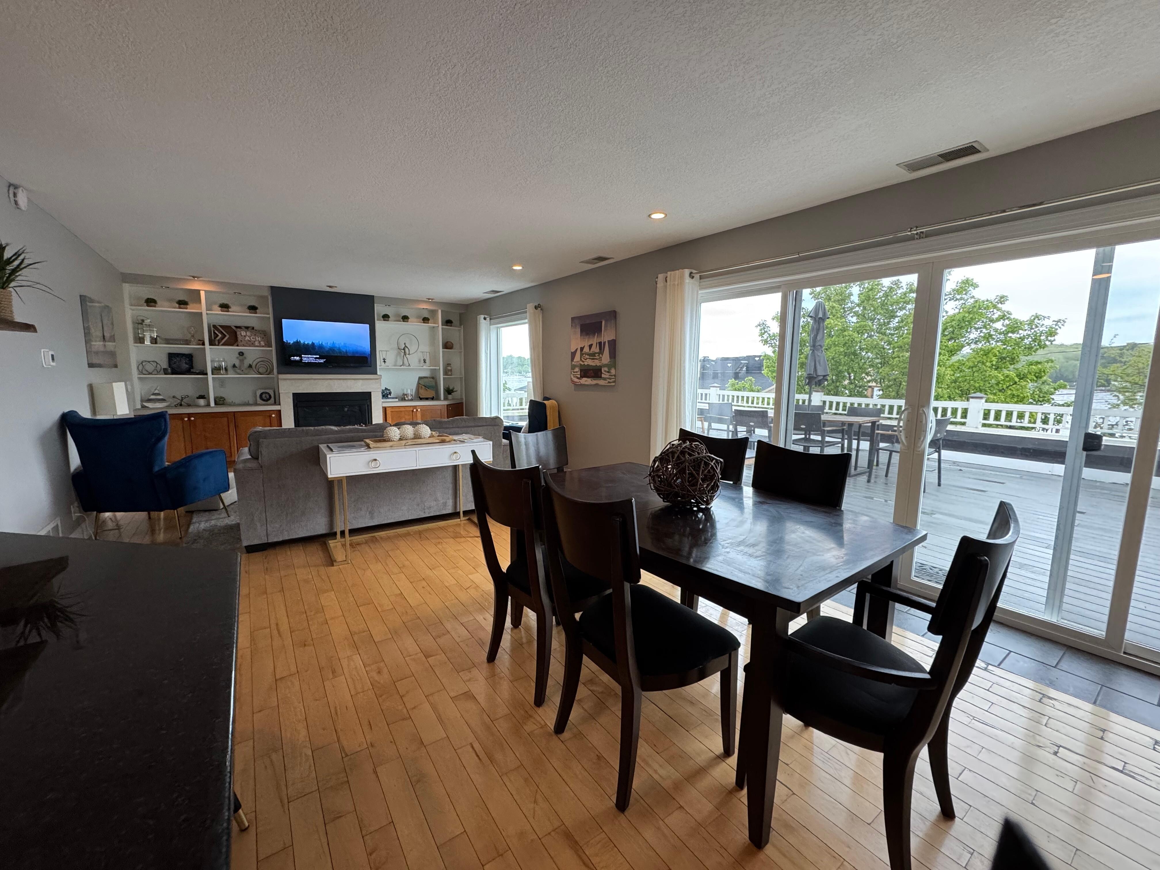 Amazing great room with lots of windows and roof top patio