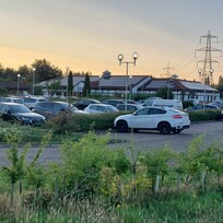 Car park and accommodation in background