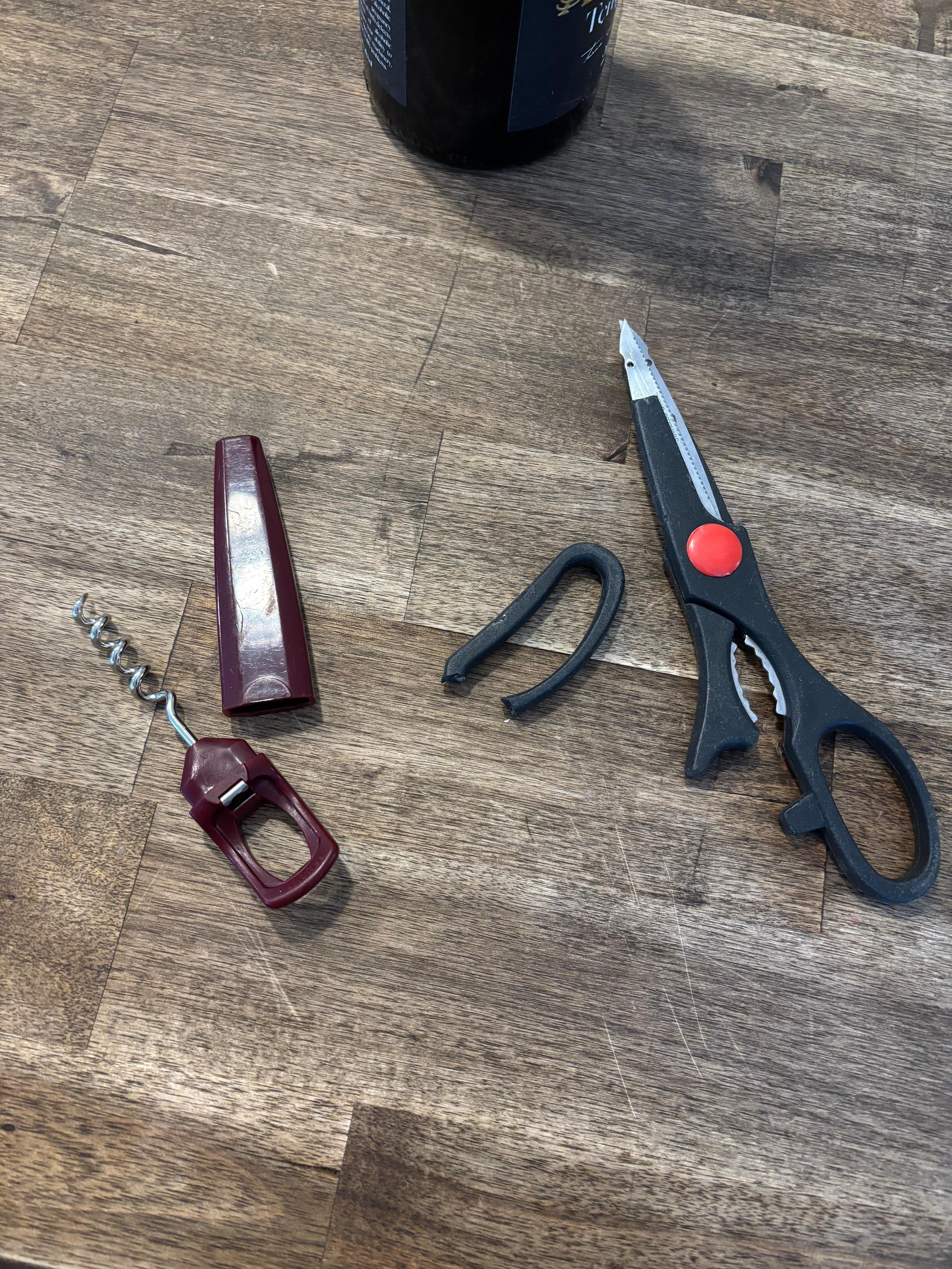 Broken wine cork screw and  cooking scissors. 