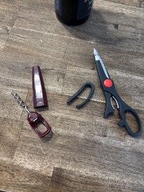 Broken wine cork screw and cooking scissors.
