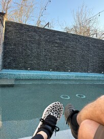 Lounging by the outdoor water feature.