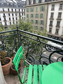 Dead plants on very tiny balcony overlooking busy, noisy street