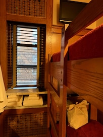 2 bunk beds, each with its own tv and just enough room to change and get into bed.