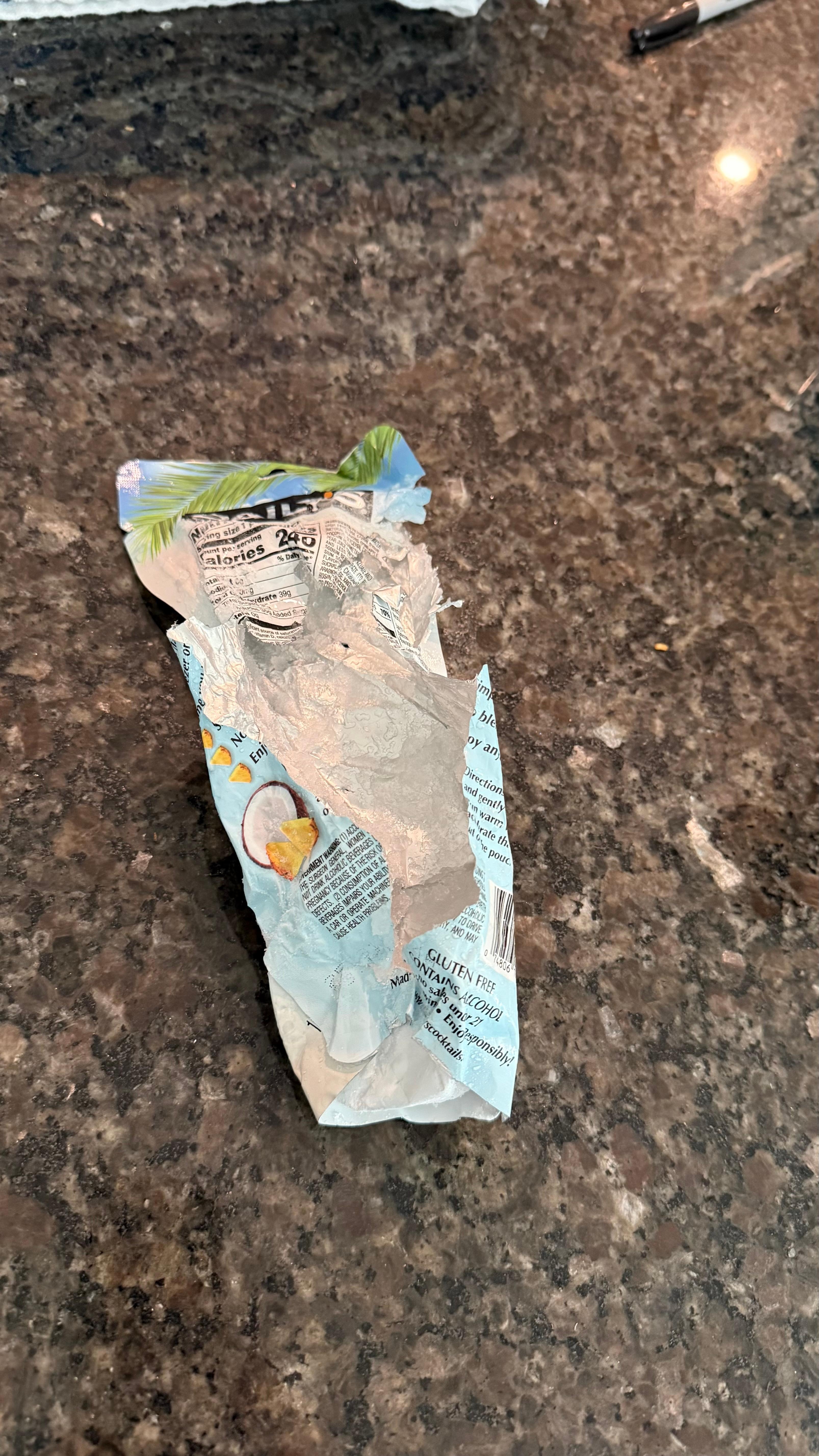 Shredded alcohol pouch from ice maker auger