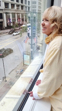 Looking out onto Washington Avenue from our room, wearing the guest robe.