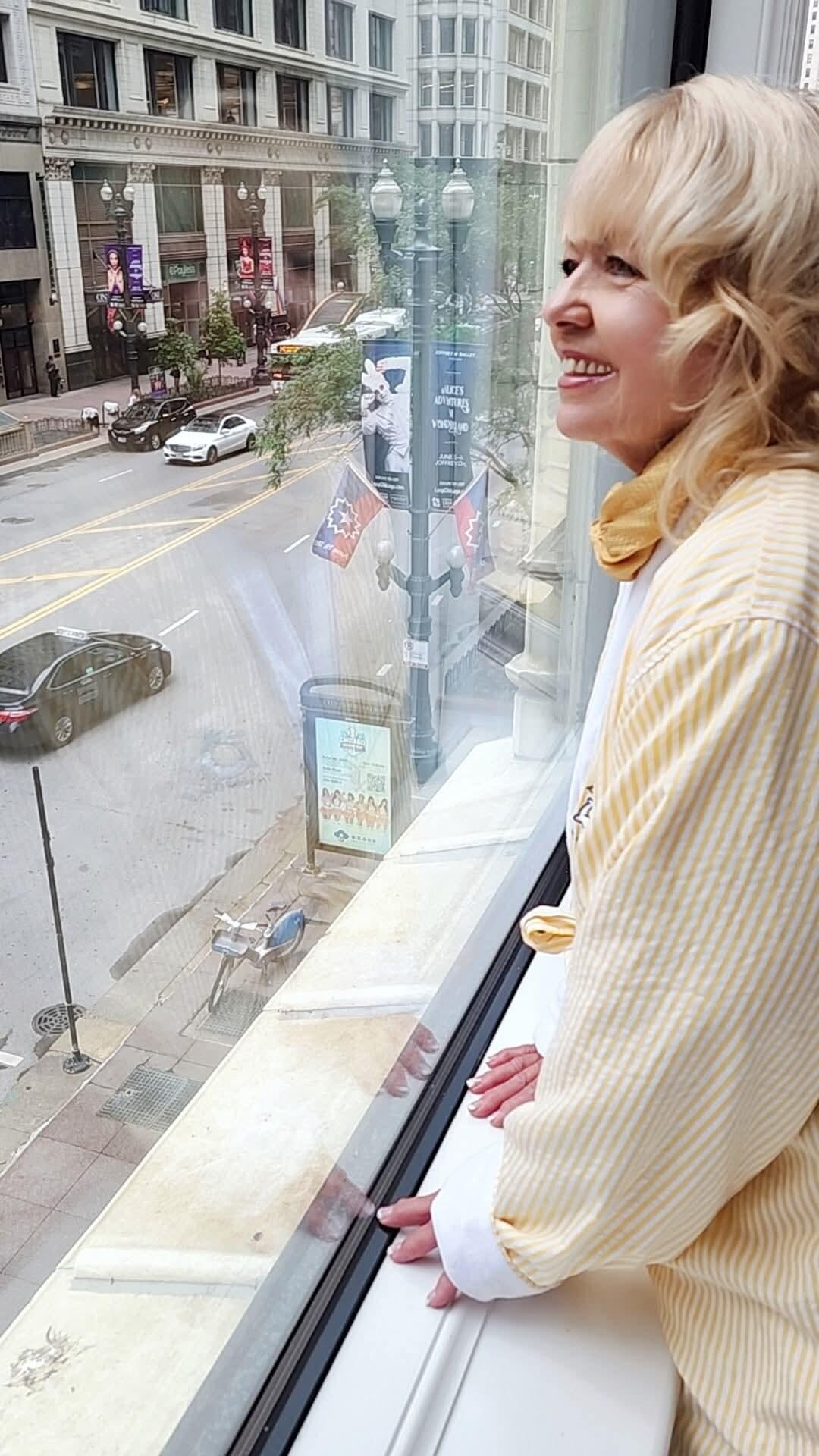 Looking out onto Washington Avenue from our room, wearing the guest robe.