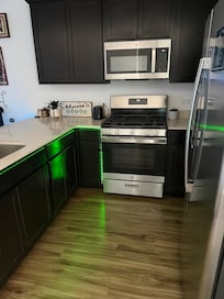 Kitchen includes a Gas stove, place settings for at least 6 people. Cooking pots, pans skillets, and a stove top griddle. Also, spatulas, tongs, serving spoons, & a small cutting board. I did NOT see any measuring cups though (if you need them).