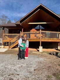 This photo was taken right in front of the cabin, and it perfectly captures how beautiful and well-kept the property is. The cabin has a classic mountain look with a spacious deck, solid wood construction, and a peaceful setting. It felt welcoming th