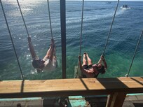 Enjoying the swings at Happy Harryâs, a short walk away.