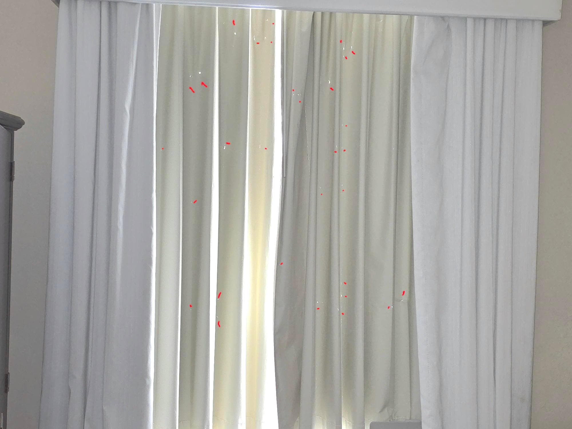 Holes in curtain. The red marks are the holes in the curtain.