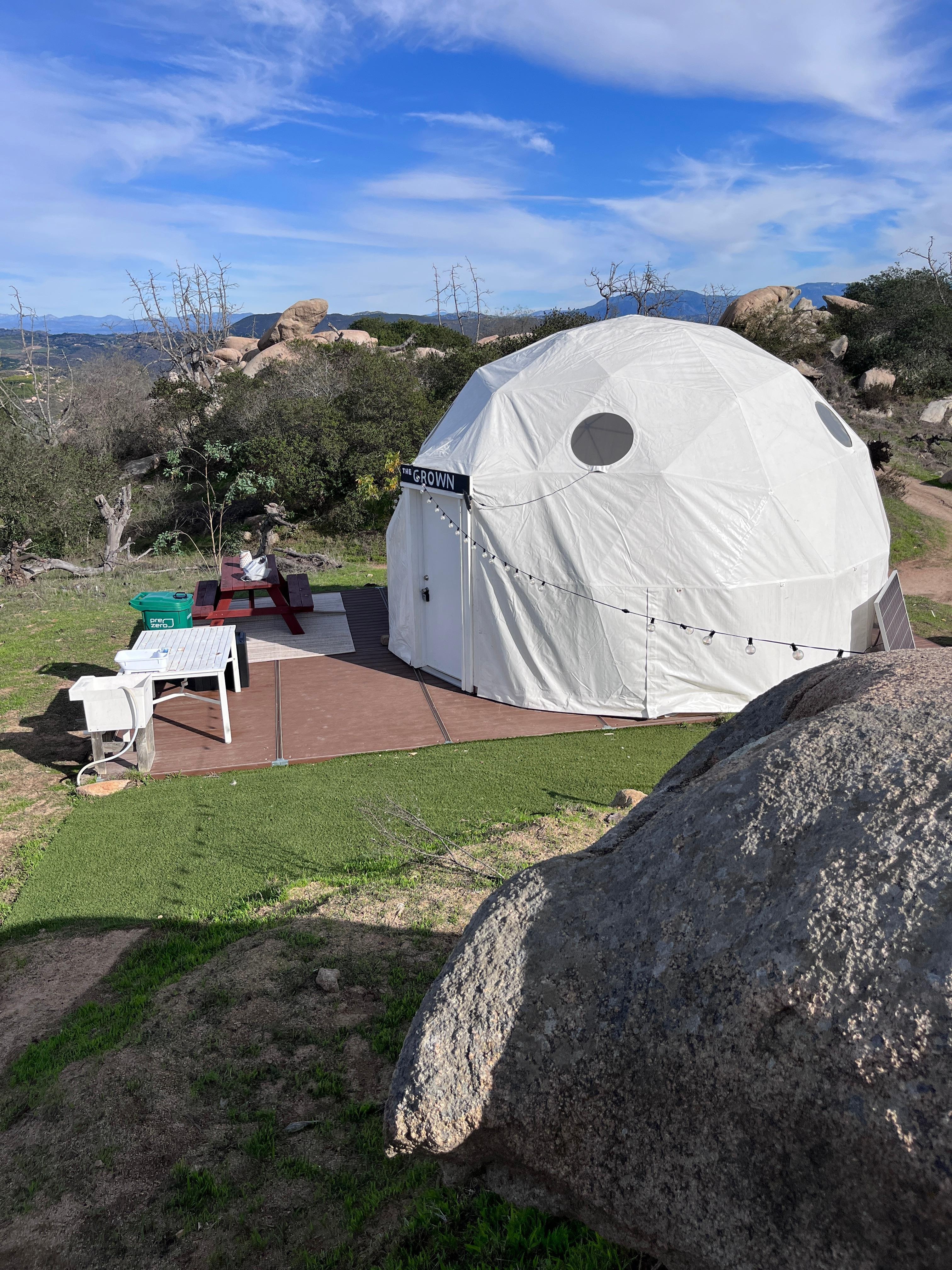 Looking down from the campfire area towards the back patio of the dome. 