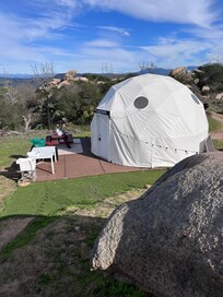 Looking down from the campfire area towards the back patio of the dome.