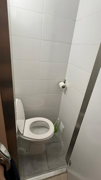 Very small space for toilet bowl. Cramped toilet.