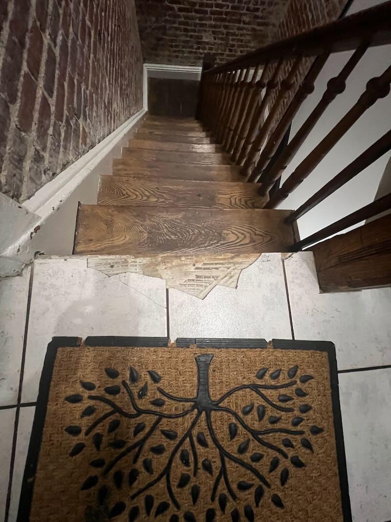 broken tile at the top of the stairs