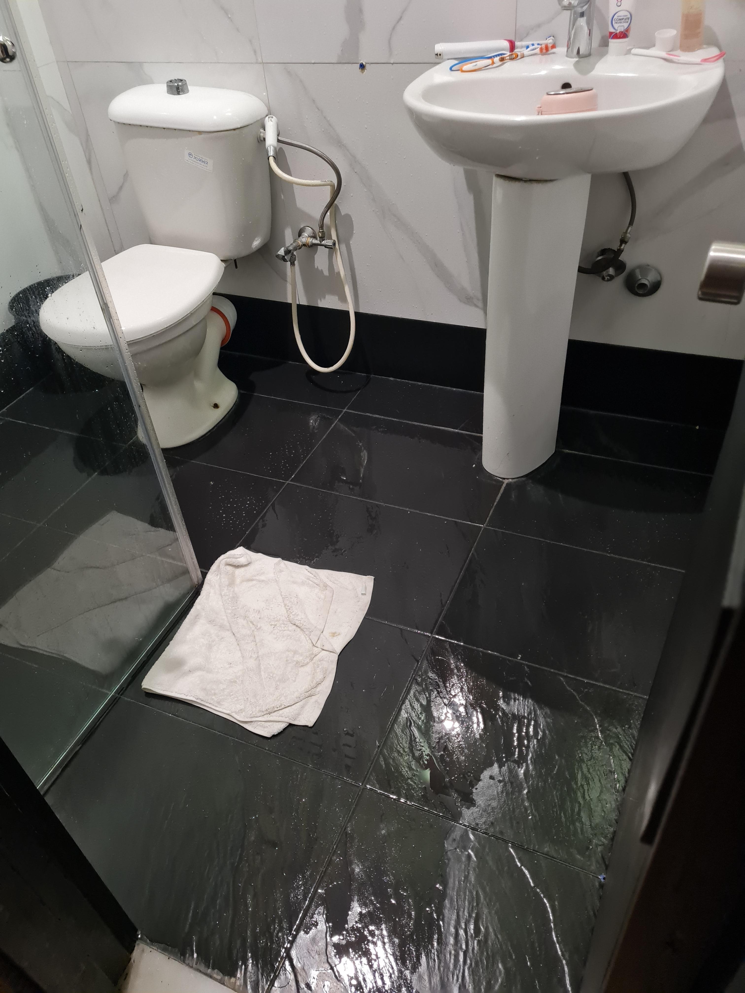 Shower door too short allowing shower head to shoot water everywhere n very wide spray