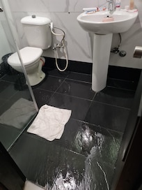 Shower door too short allowing shower head to shoot water everywhere n very wide spray