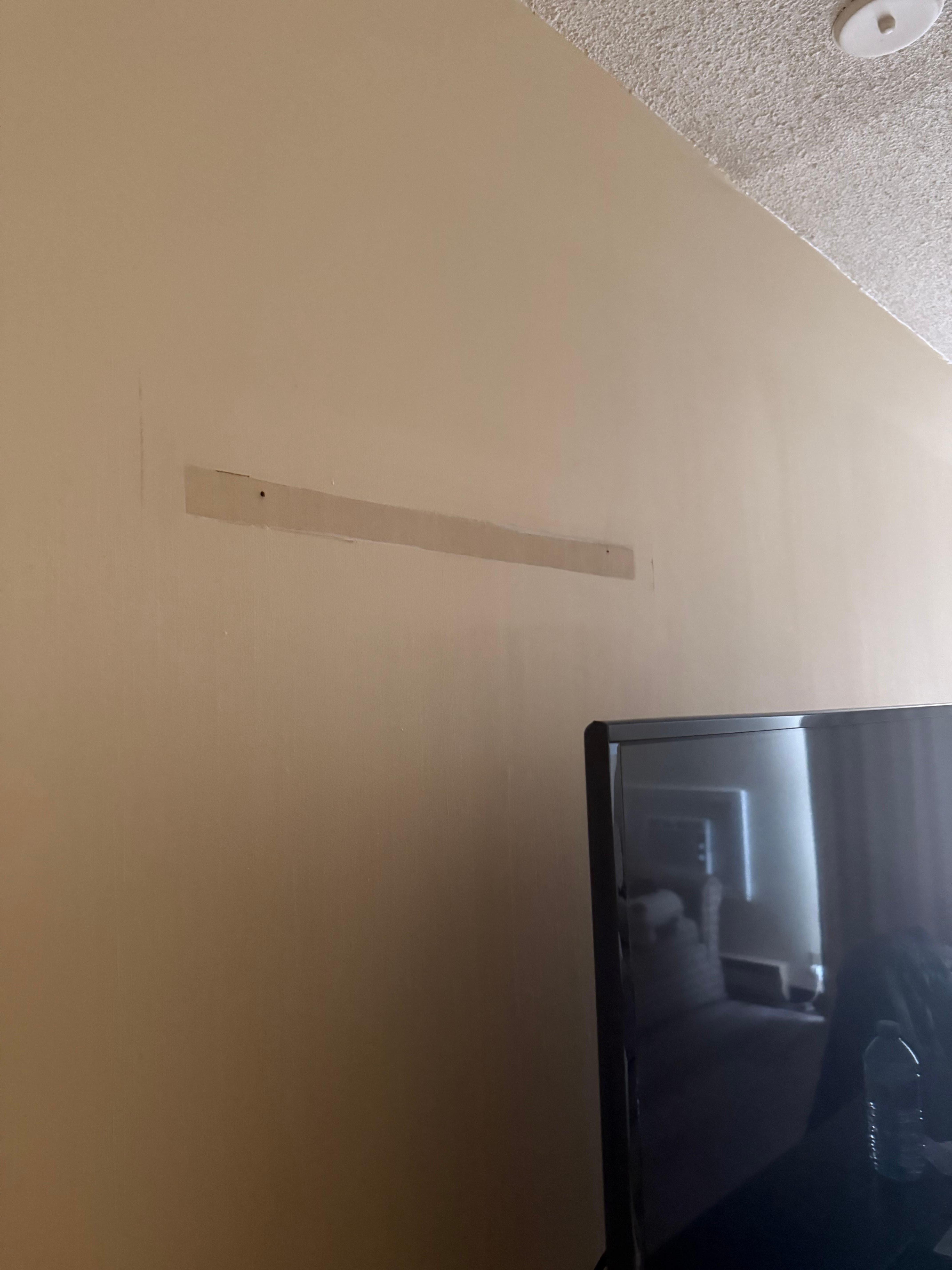 Exposed wood, screws (where pictures once hung?)