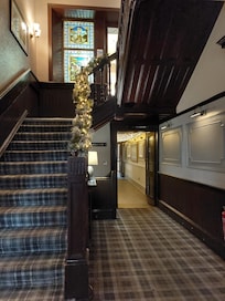 Festive additions to reception areas on top of Scottish themed stained glass or frosted windows with portraits of Scottish historical characters and events along the corridors