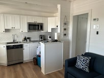 Bright, clean kitchen area with appliances and Keurig coffee maker