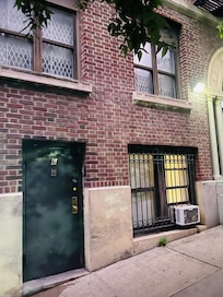 Front Door. Apartment is on bottom level. The windows overlook alley and sidewalk.
