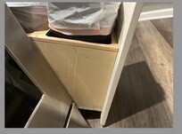 trash receptacle falls out of place when opening