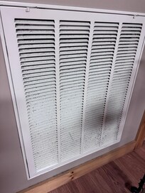 Return air vent w/ dirty filter in basement.