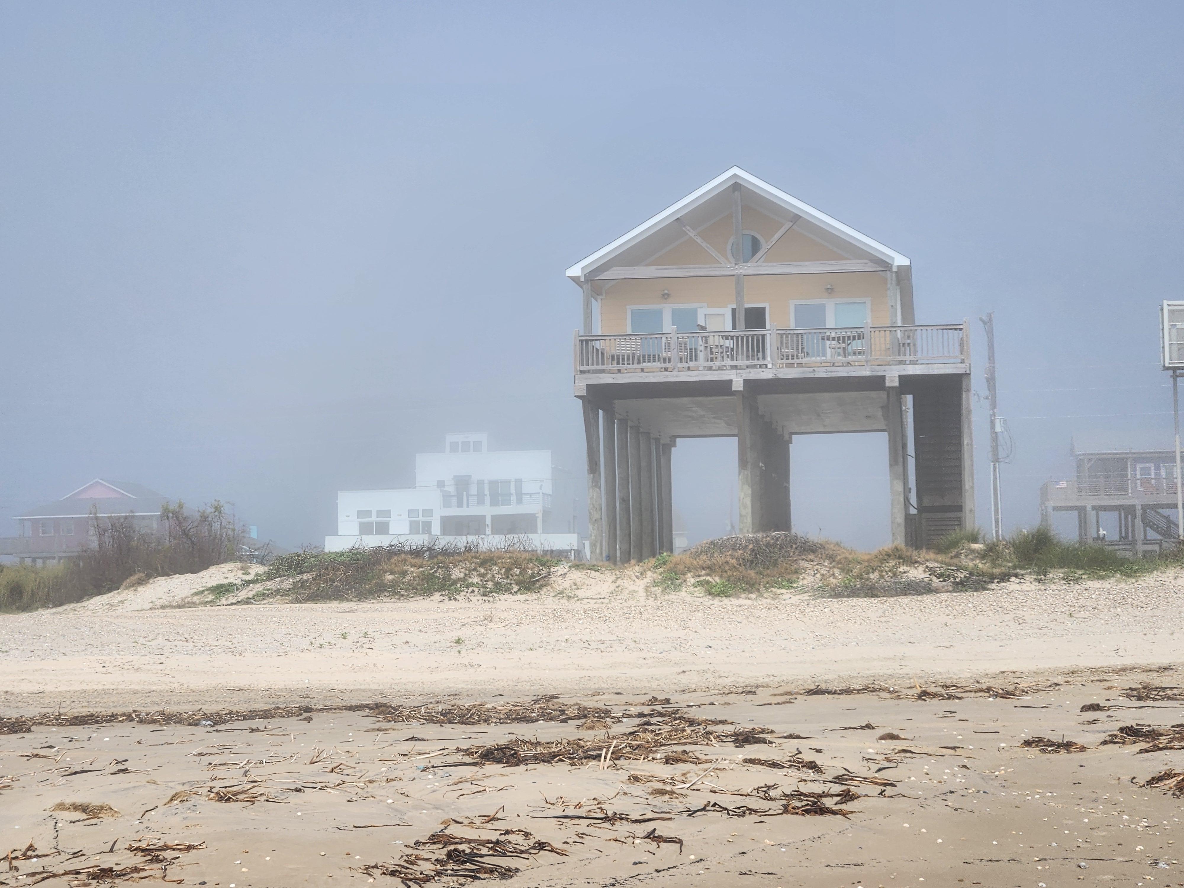 View of the house from the beach in the fog