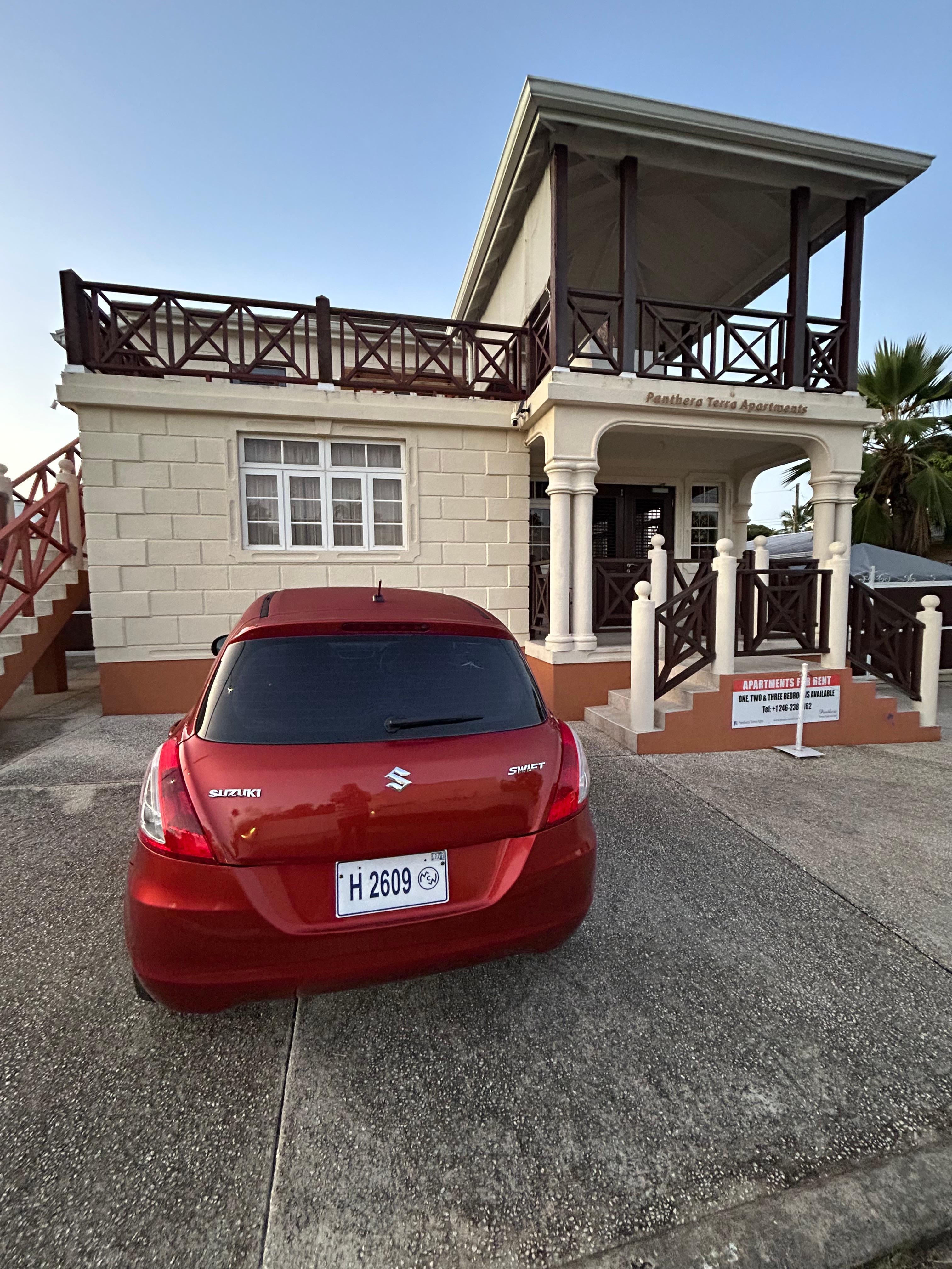 Our hire car outside the apartment. Apartment 2 is on the upper floor, where the large balcony can easily be seen