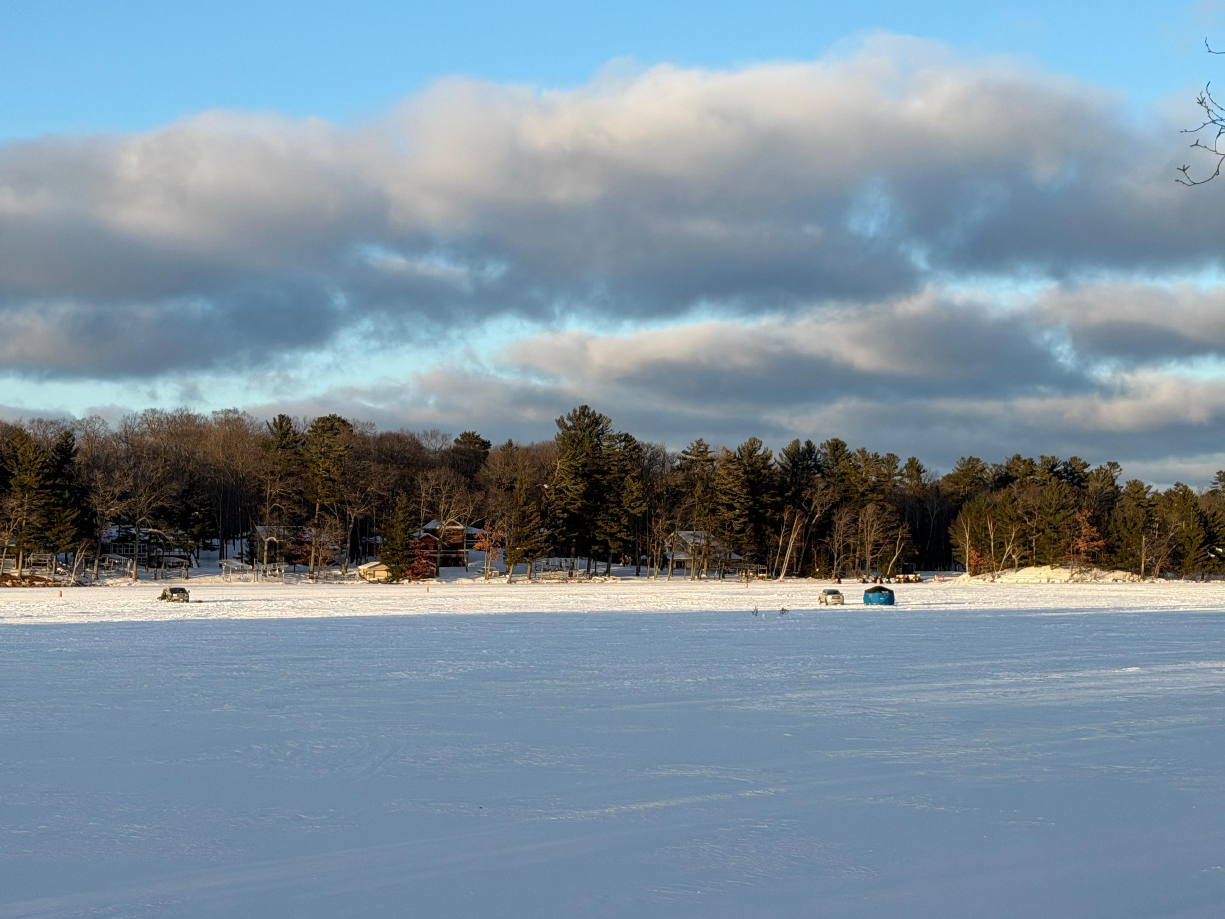View from living room of ice fishermen and snowmobilers