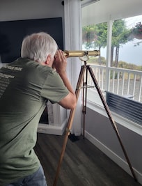 Using the house telescope to see out to the Strait of Juan de Fuca.