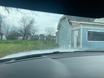 Side of house with steps that are rotten and door barely locks