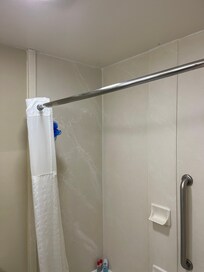 Shower rod almost off the wall, curtain will not stay on the ends to keep water in.