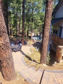Steps going down to the lower level, table chairs, Hammock, Hot Tub and Fire Pit area