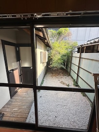 Outside the house the garden and the door for the toilet and the bath/shower room