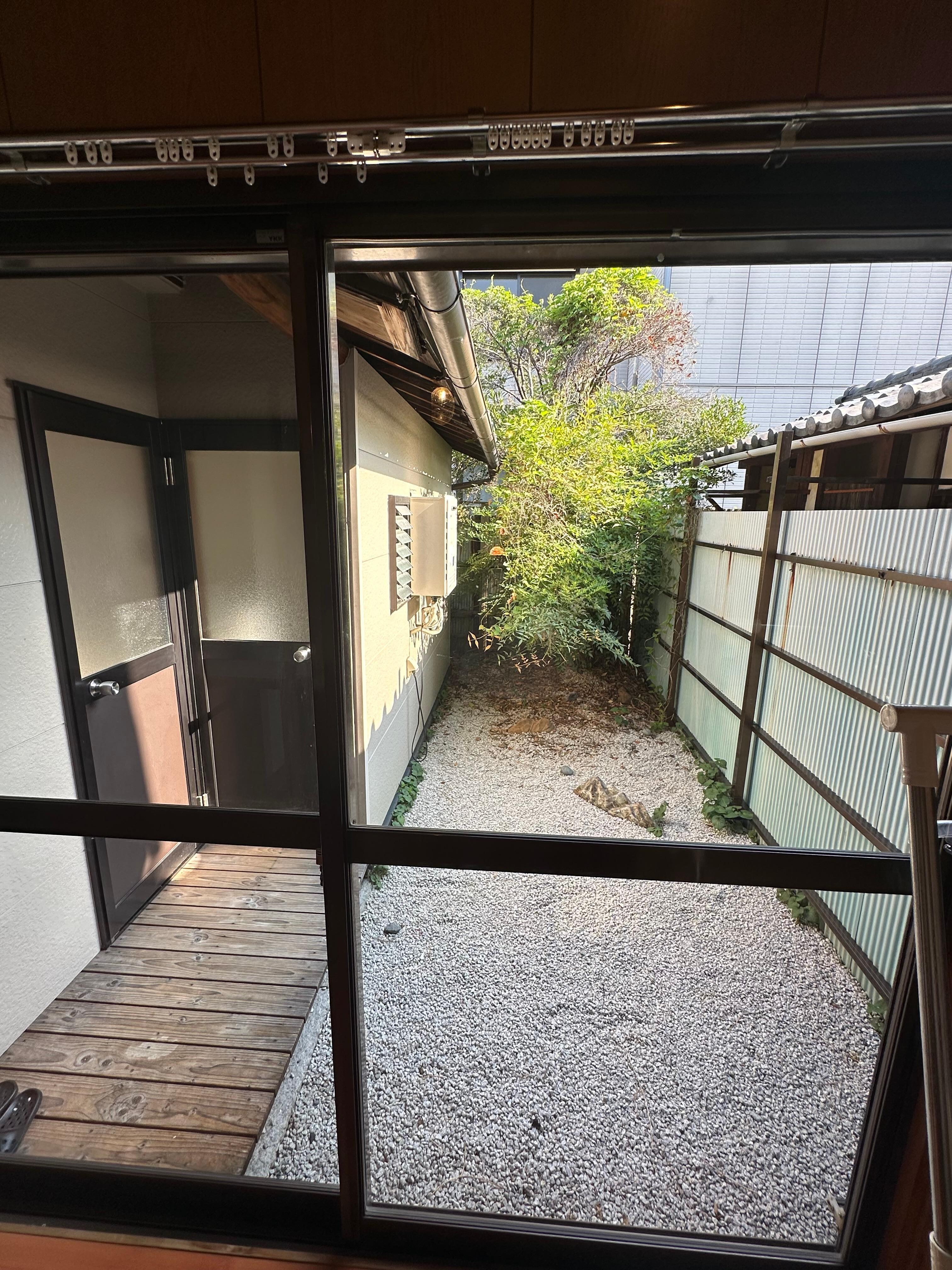 Outside the house the garden and the door for the toilet and the bath/shower room