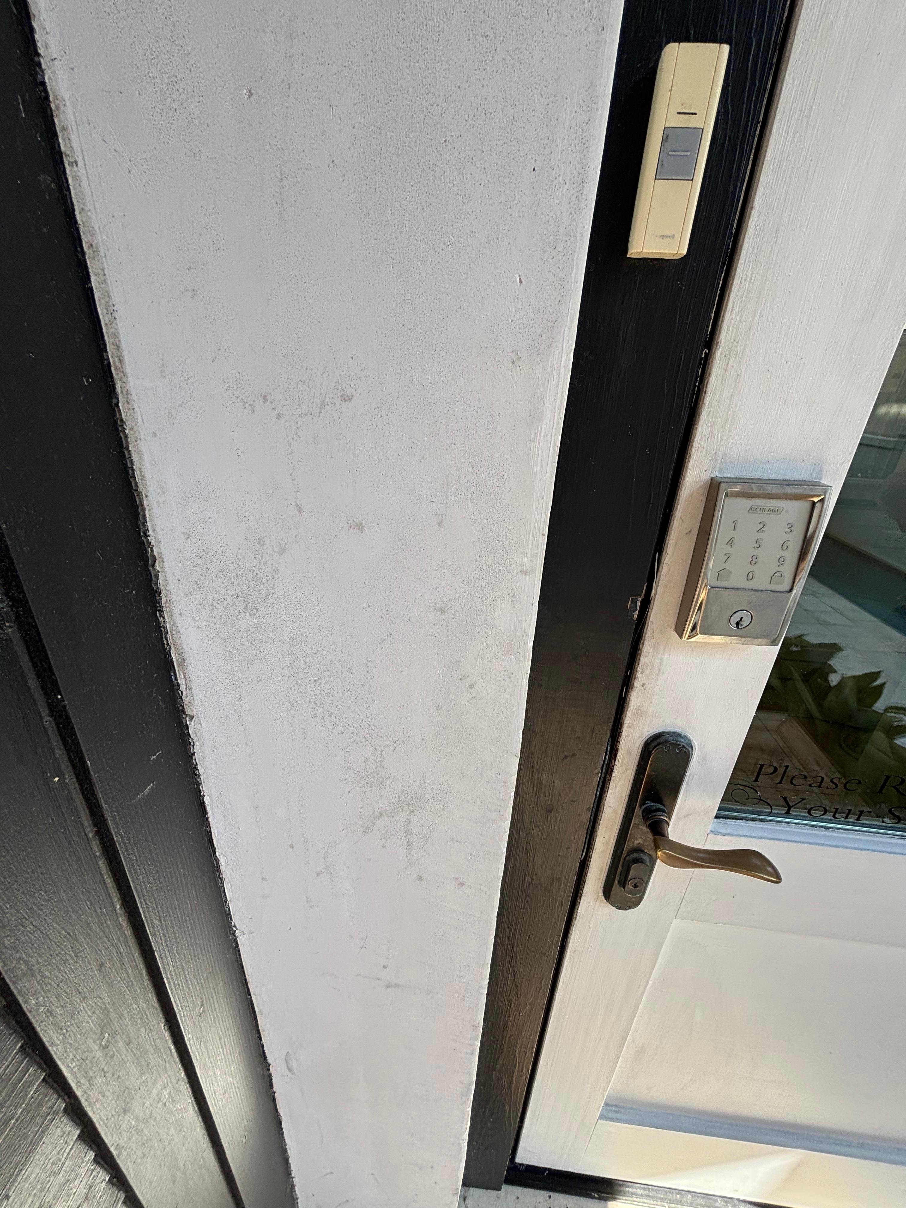 Exterior door frame needing cleaning.