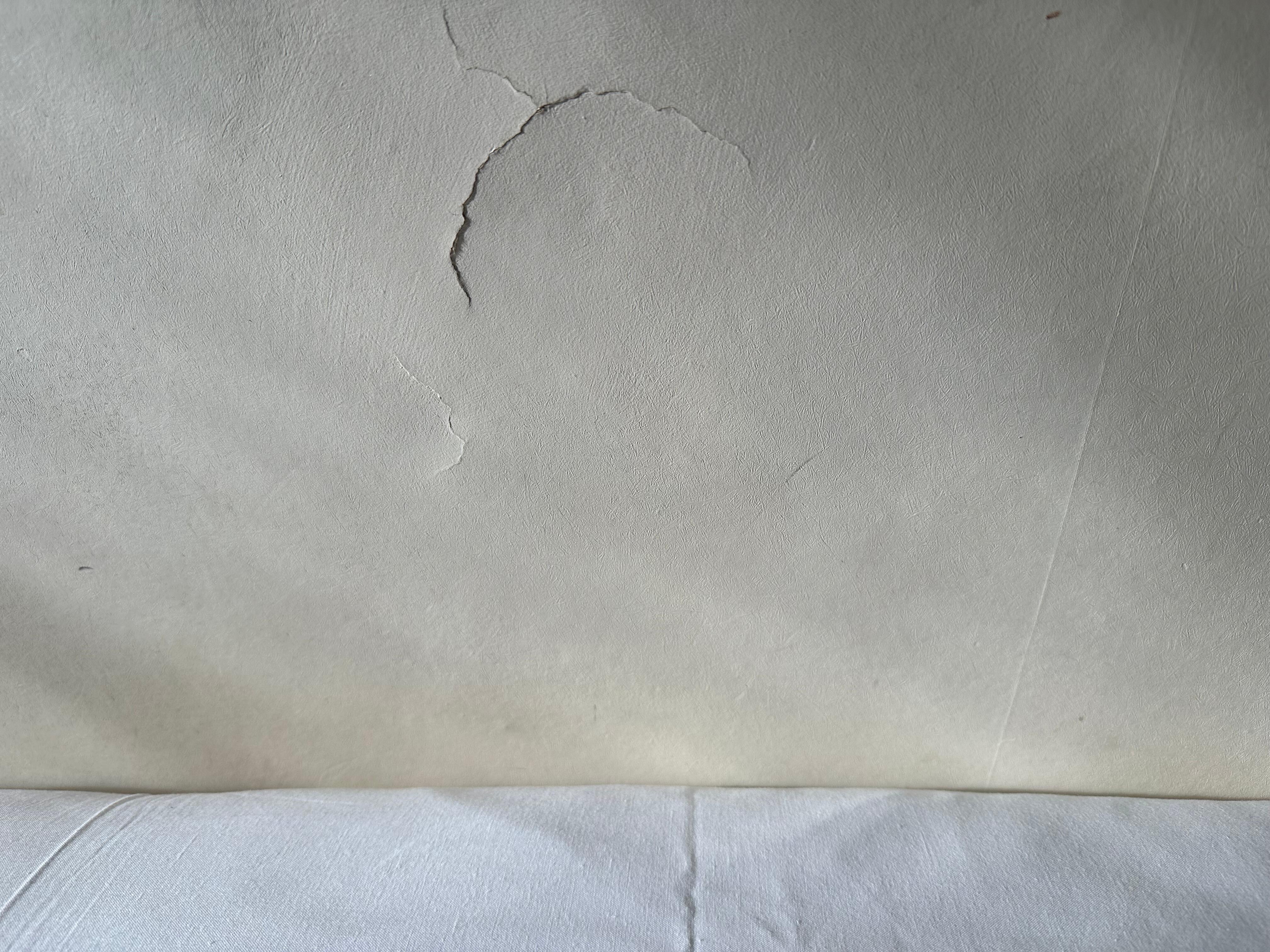 Wall next to bed peeling